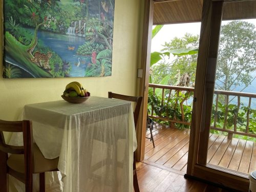 Wooden dining table set with organic meals at Dharma Vida Retreats.