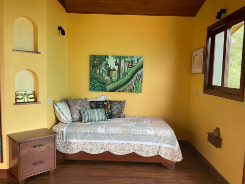 Comfortable guest room with a cozy bed and nature-inspired interiors.