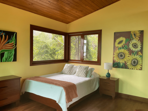 Comfortable guest room with a cozy bed and nature-inspired interiors.